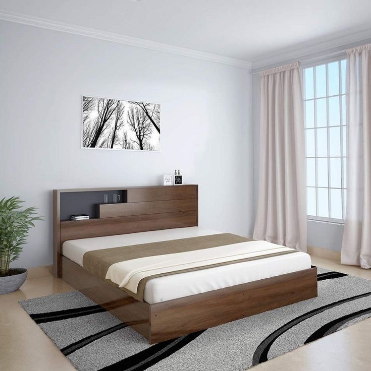 a bedroom with white walls and wood furniture