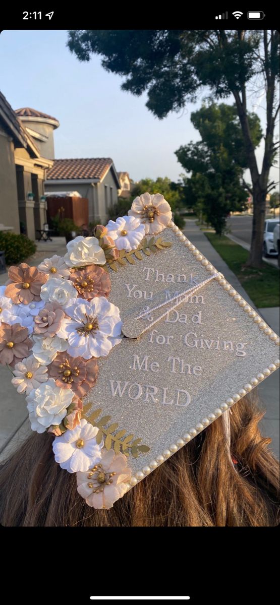 a person wearing a graduation cap with flowers on it