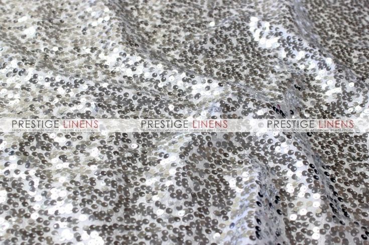 silver and white sequinized fabric with black dots