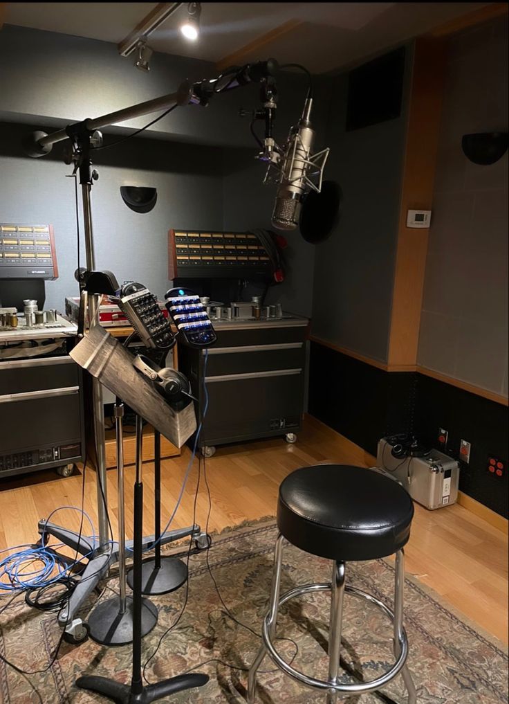 a recording studio with stools and equipment