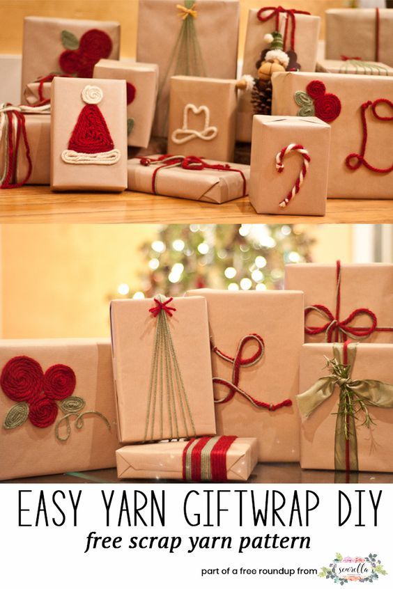 christmas presents are wrapped in brown paper and tied with red twine ribbons, sitting on a table