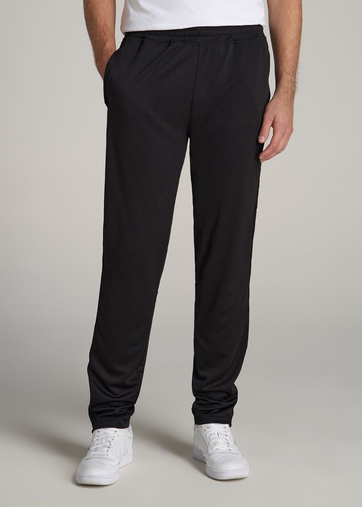 About Our Tall Men's Pants These men's tall athletic pants are a classic take on an athleisure essential. When it comes to athleisure, a good fit is key. You need something that's comfortable enough to relax in yet capable enough to work out in – but as a tall guy, it can be hard to find options that work for your height. You either have to compromise on a baggy fit or settle for lengths that are way too short. Not anymore. We know how hard it is to find quality styles when you're tall, which is Black Activewear With Comfort Waistband And Tapered Leg, Black Tapered Leg Activewear With Comfort Waistband, Black Tapered Leg Sweatpants In Athleisure Style, Black Tapered Leg Athleisure Sweatpants, Black Tapered Leg Activewear For Jogging, Black Joggers With Comfort Waistband And Tapered Leg, Black Tapered Leg Joggers With Comfort Waistband, Black Tapered Leg Activewear For Sports, Black Tapered Leg Athleisure Activewear