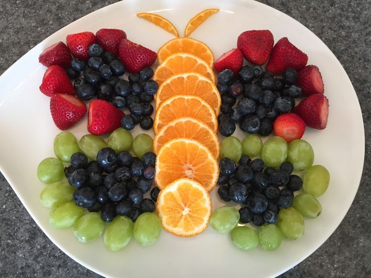 a white plate topped with fruit and vegetables