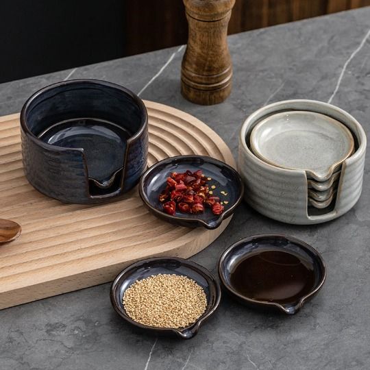 three bowls and two spoons on a wooden tray