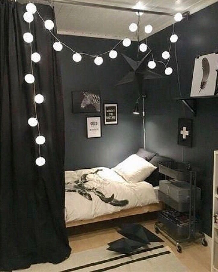 a bedroom with black walls and white lights