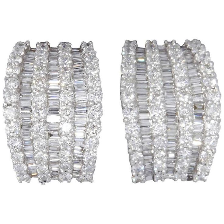 An incredible huggie hoop style earring. Unique in design and full of SPARKLE! 5.81 carats of F color VS clarity baguette and round brilliant cut diamonds set in 18k white gold. .57 inches at its widest point, .86 inches tall -- approximately. Luxury Baguette Diamond Earrings For Party, Luxury Baguette-cut Diamond Earrings For Wedding, Luxury Round Cut Baguette Diamond Earrings, Luxury Baguette Diamond Hoop Earrings, Luxury White Baguette-cut Diamond Earrings, Earring Unique, Baguette Diamond Earrings, Bling Ideas, Earrings For Sale