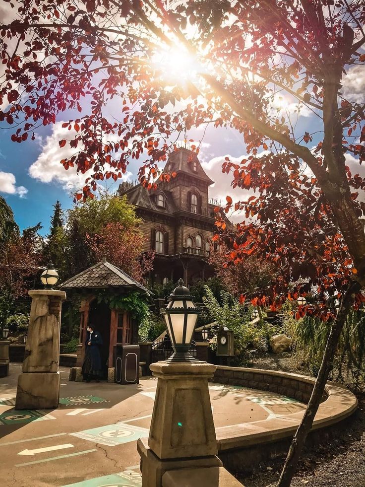 the sun shines brightly in front of an old - fashioned house on a sunny day