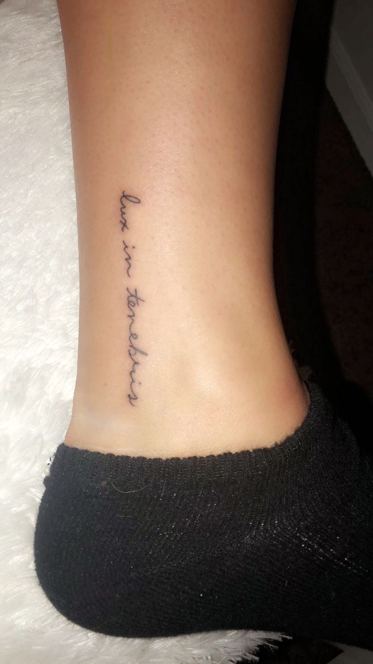 a woman's foot with a tattoo that reads, i love you to the moon and back