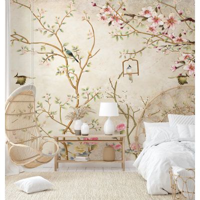 a bedroom decorated in white and pink with flowers on the wall, birdcage