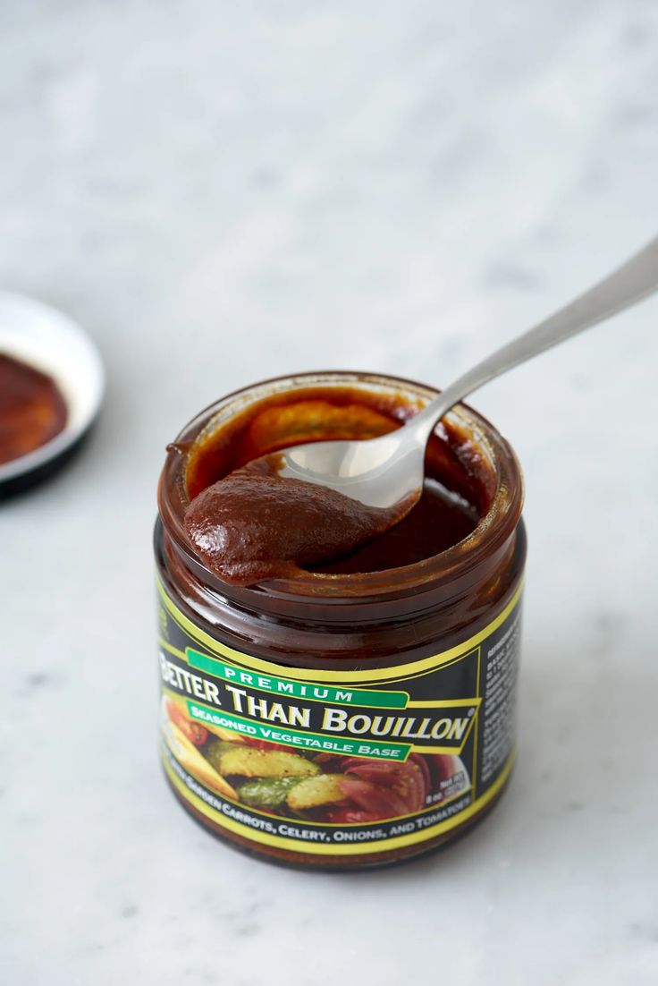 a spoon is in a jar of barbecue sauce