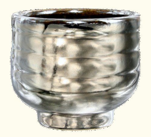 a silver vase with wavy lines on the bottom and sides, sitting in front of a white background