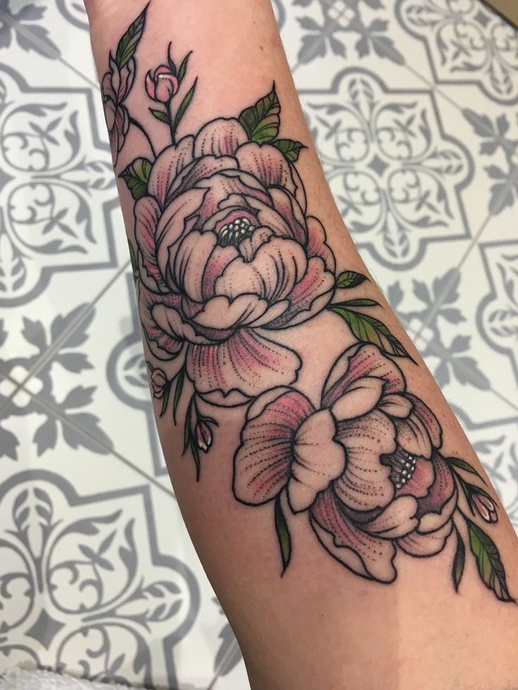 a woman's arm with flowers on it