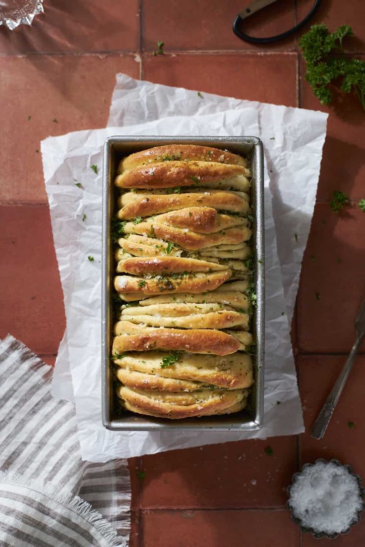 a pan filled with bread sitting on top of a table