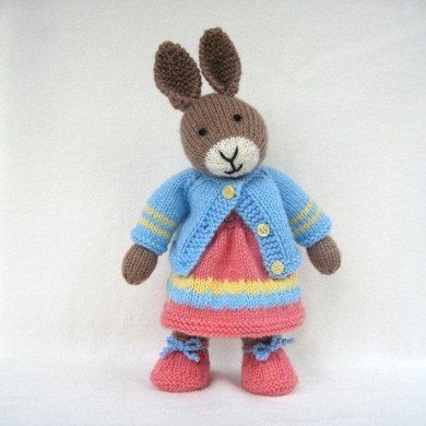 a knitted rabbit wearing a dress and jacket