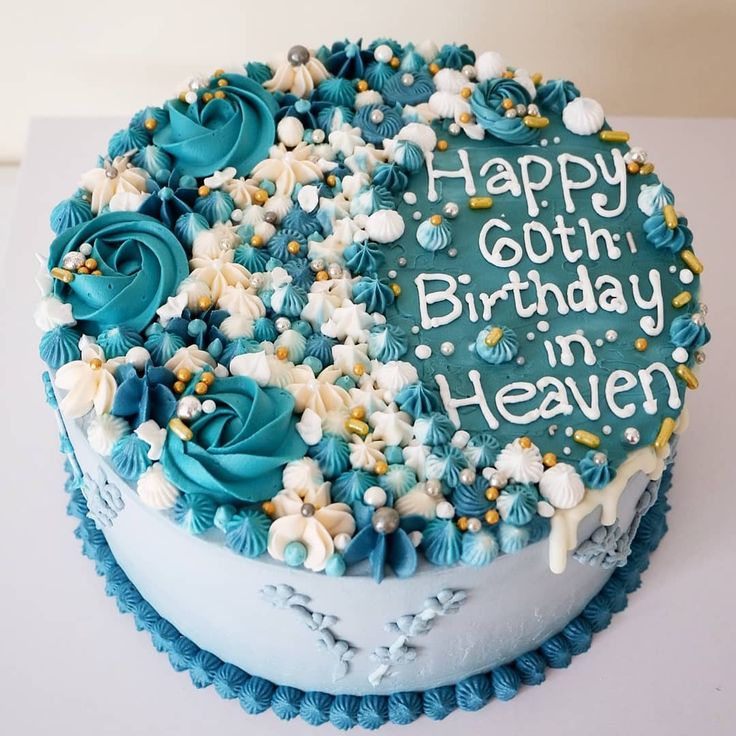 a birthday cake with blue frosting and white flowers