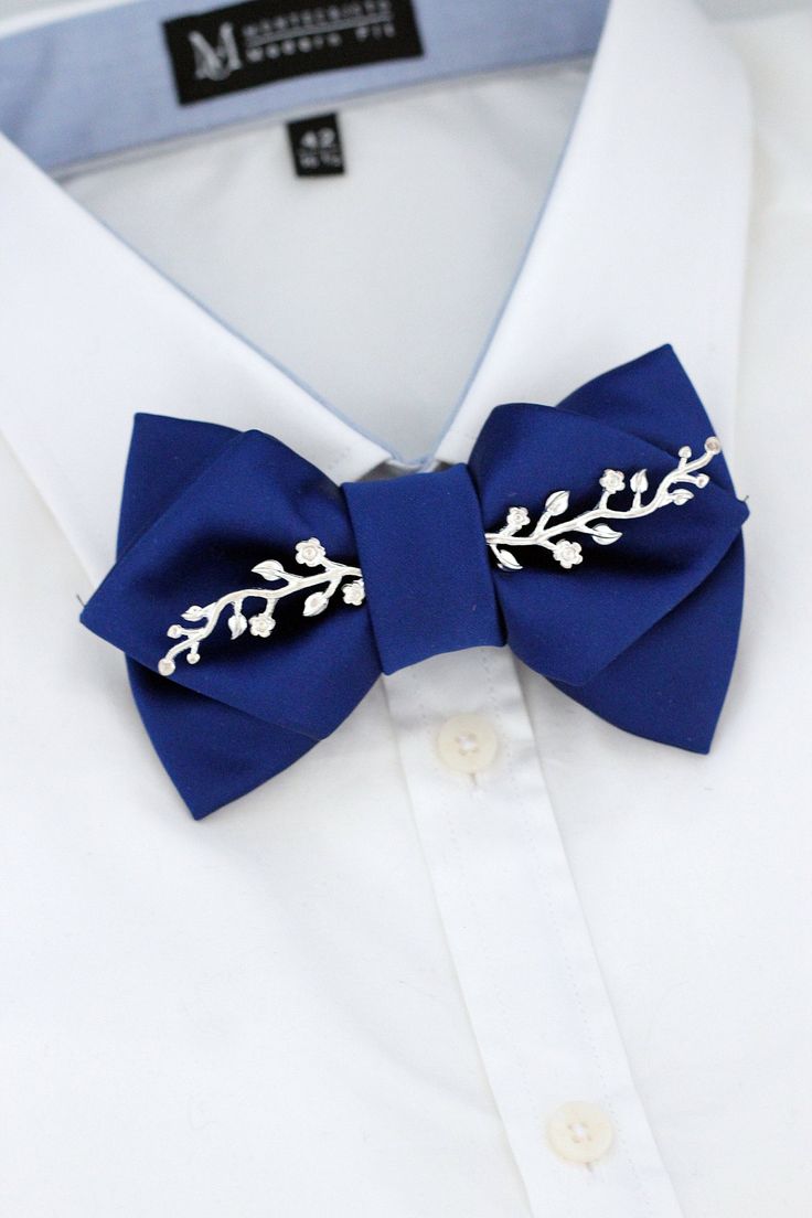 This is a big royal blue mens satin butterfly bow tie with silver rhinestone appliques and boutonniere set. Suitable as a tuxedo suit wedding bow tie or groomsmen bow tie gift. Also can be for boys prom, homecoming bow tie. Made in Europe out of premium not too shiny satin cotton fabrics. Our bow ties are handmade in Europe with much love and Sense for the detail. Material for the bow tie is European satin. We offer different bow tie sizes.  MENS BOW TIE is pre-tied approximately 4.3-inch x 3 inch big. It comes with and Adjustable fabric strap with metal hardware for neck size 14 inch to 19.5 inch.  BOUTONNIERES are a colour match to the bow tie and are 2 inch big.  We also offer matching suspenders and pocket squares.   If you decide to order set, we have different set options depending o Royal Blue Bow Tie, Blue Tux, Formal Ideas, Prom For Guys, Groomsmen Gift Set, Flower Boutonniere, Wedding Bow Tie, Groomsmen Bowtie, Groomsmen Wedding