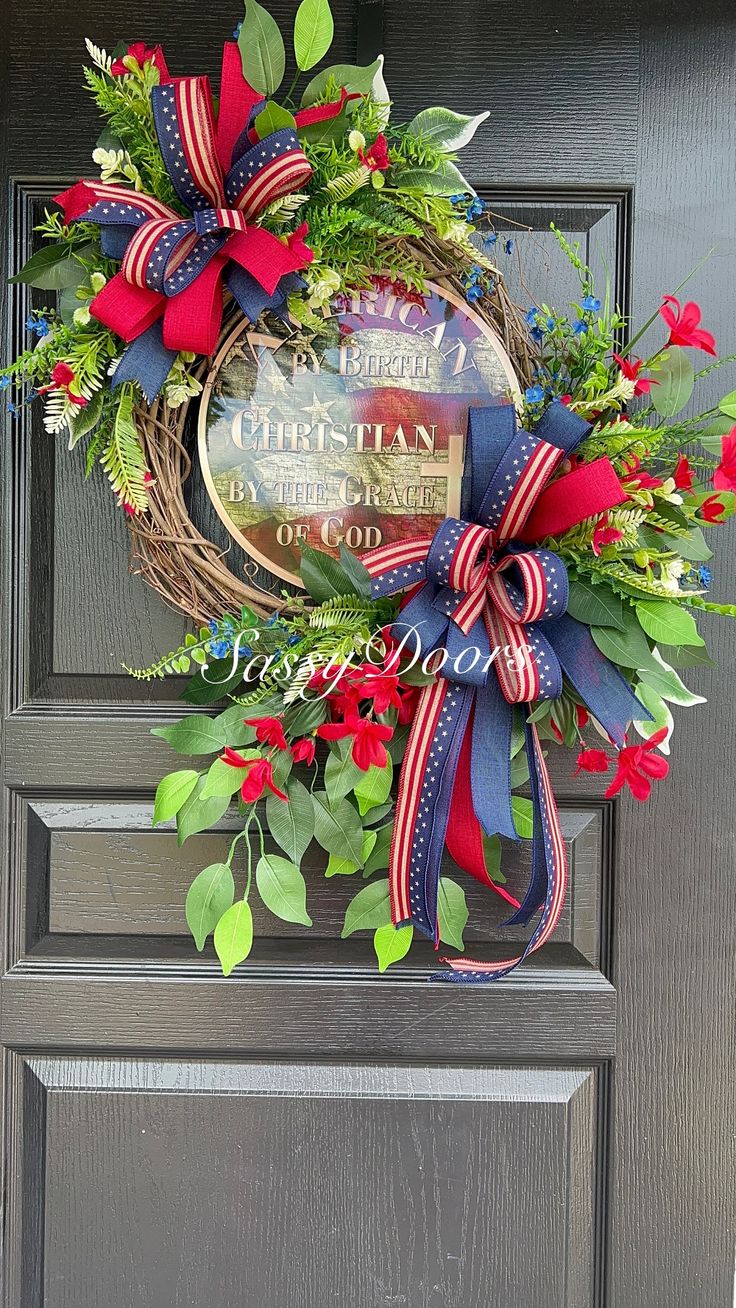 a wreath with red, white and blue ribbons hanging on the front door to celebrate christmas