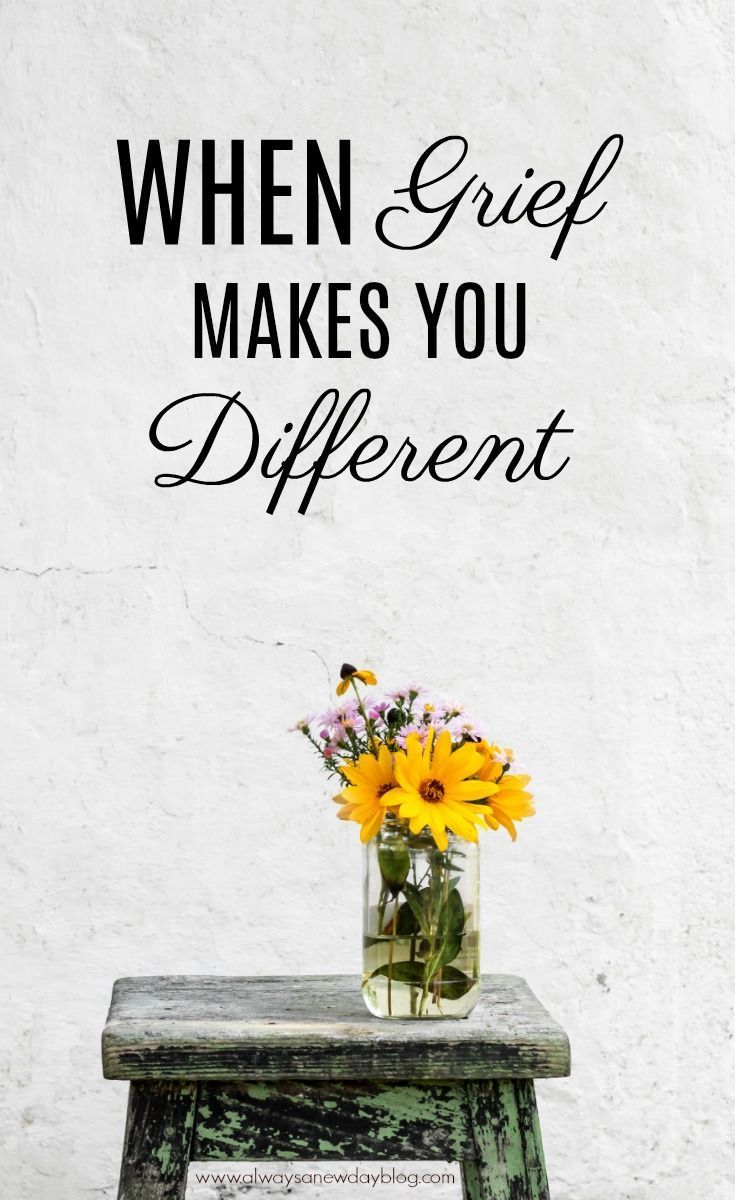 a vase filled with yellow flowers sitting on top of a wooden table next to a white wall