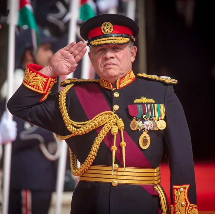 an older man in uniform saluting to the crowd