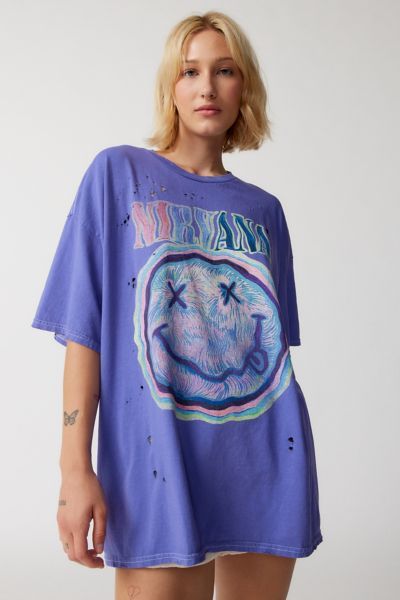 One of our fave graphic tees - an oversized t-shirt dress topped with Nirvana graphics at the front and back. Washed-soft and faded with distressed details for a vintage look and feel. Oversized fit so you can wear it as a tee or a t-shirt dress and overdyed for a worn-in finish. Only available at Urban Outfitters. Content + Care 100% Cotton Machine wash This item has been overdyed and may transfer dye. We recommend that you wash this item separately a few times before wearing. Imported Size + F Oversized Graphic Print Top From Urban Outfitters, Oversized Blue Grunge Top, Urban Outfitters Summer Grunge Tops, Urban Outfitters Grunge Tops For Summer, Oversized Purple Screen Print Top, Trendy Oversized Tops From Urban Outfitters, Oversized Short Sleeve Tops By Urban Outfitters, Urban Outfitters Oversized Short Sleeve Tops, Urban Outfitters Grunge Short Sleeve Tops