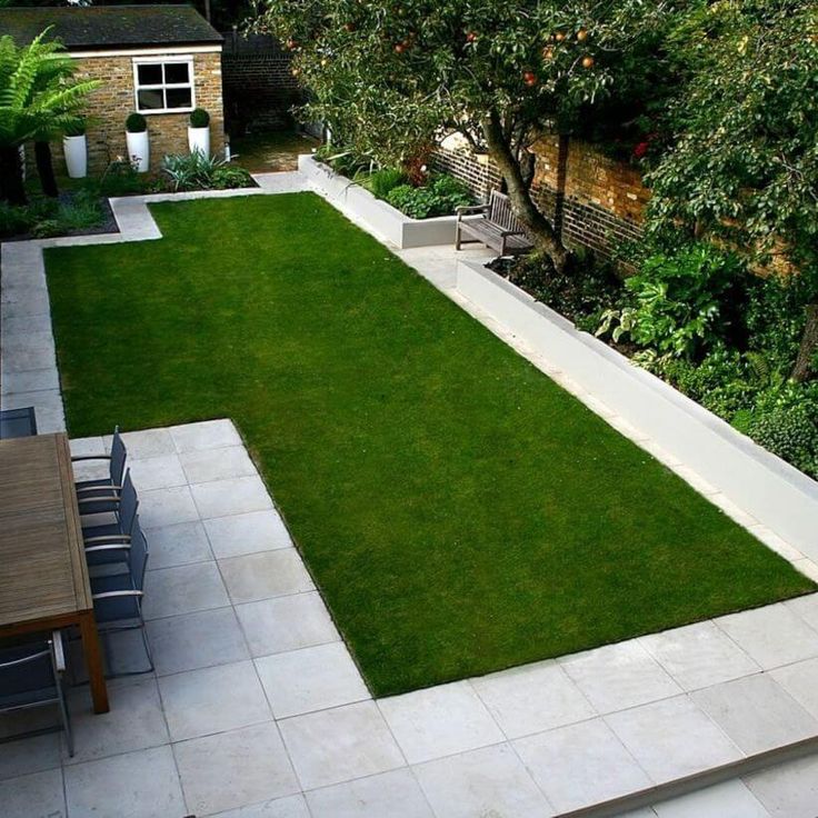 an outdoor garden with grass and lawn furniture