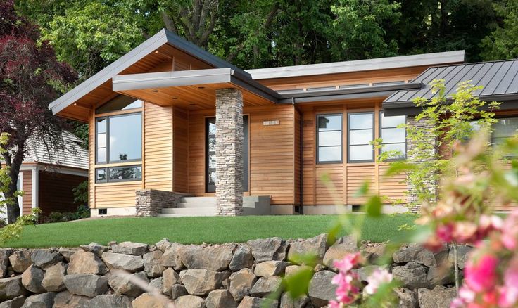 a small wooden house sitting on top of a lush green field