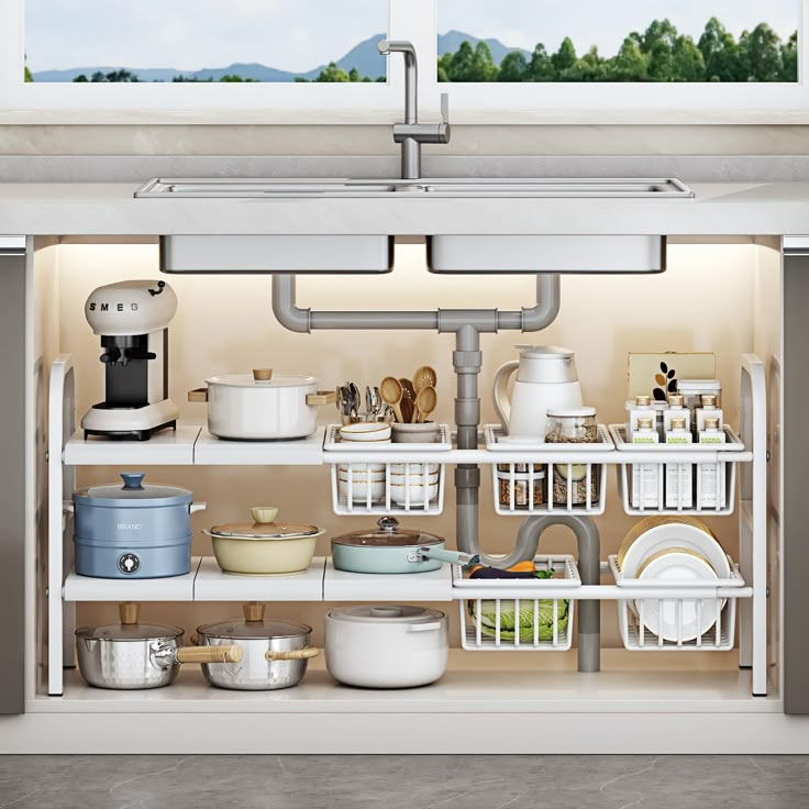 an open kitchen cabinet with dishes and pans on the shelves, in front of a window