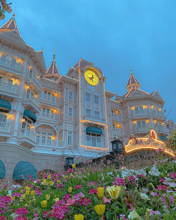 a large building with lots of flowers around it