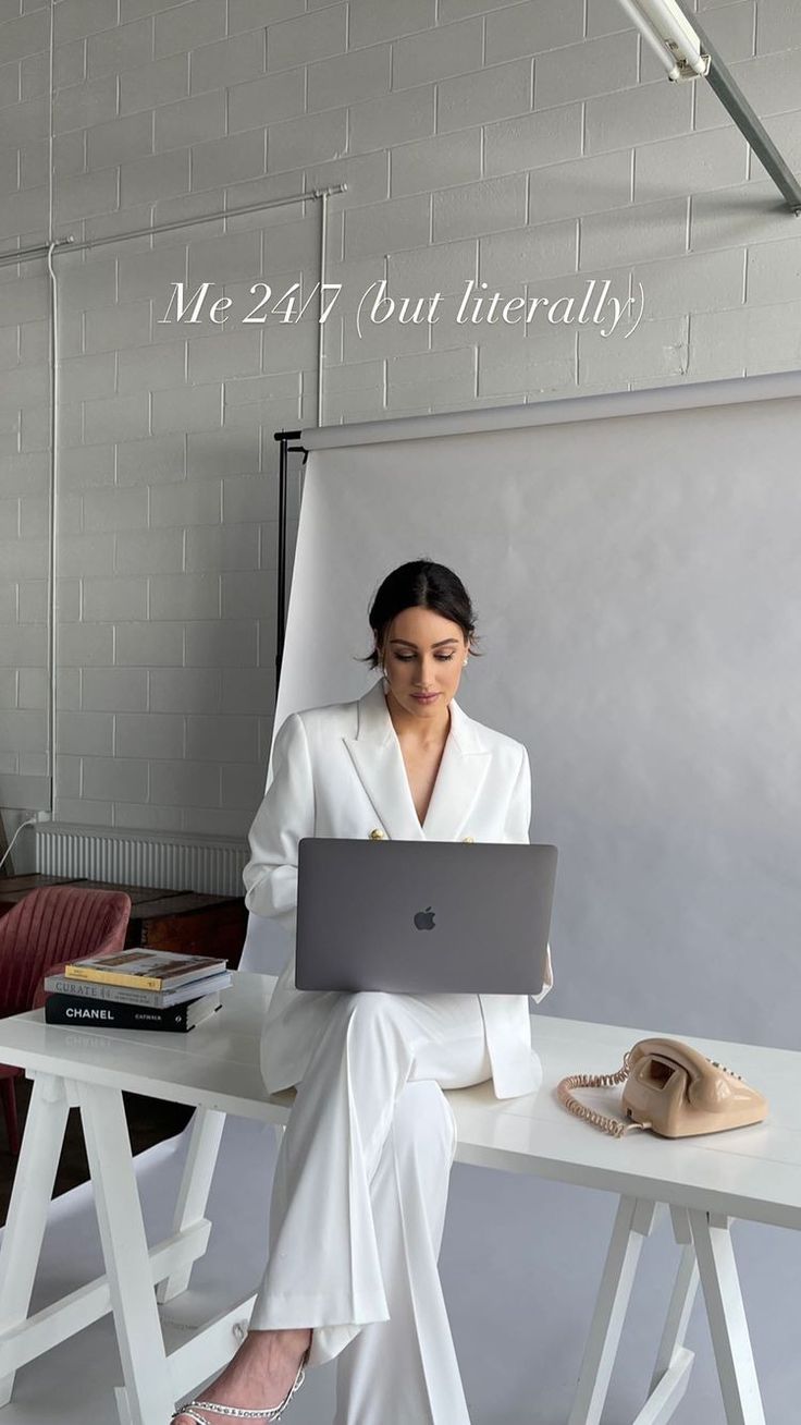 a woman sitting at a desk with a laptop