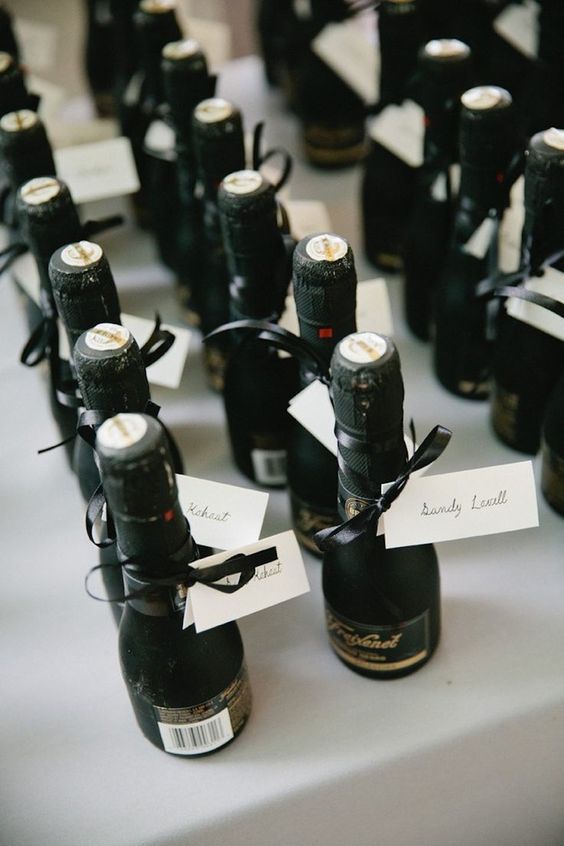 many small bottles with labels on them are lined up next to each other and tied together