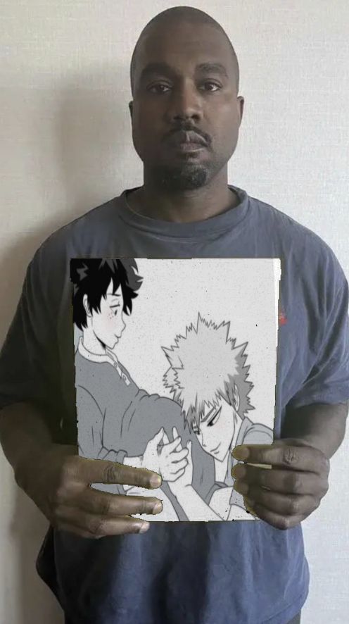 a man holding up a drawing of two anime characters