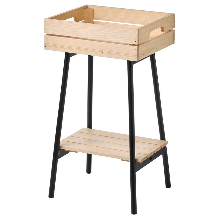 a wooden shelf with black legs and a tray on the top that has an open drawer