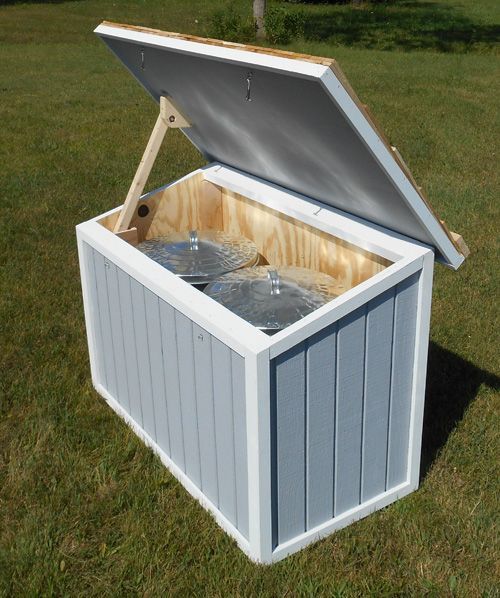 an open storage box sitting in the grass