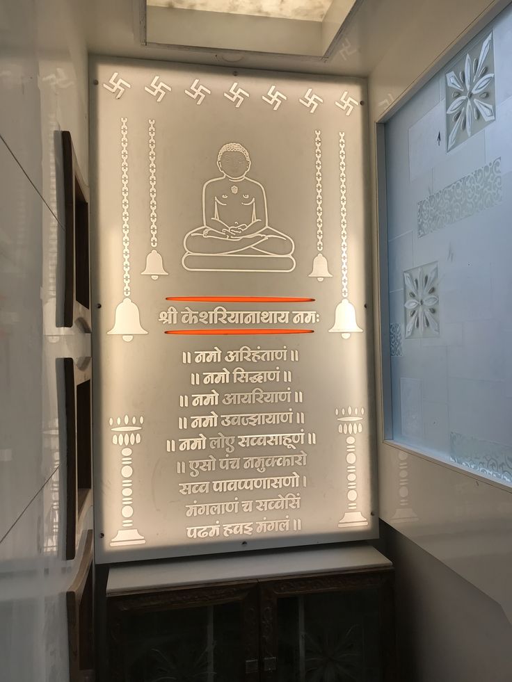 a glass sign in front of a window with an image of a buddha on it