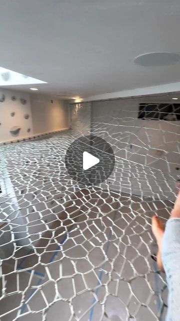 someone is taking a photo in an empty room with cracked tiles on the floor and walls