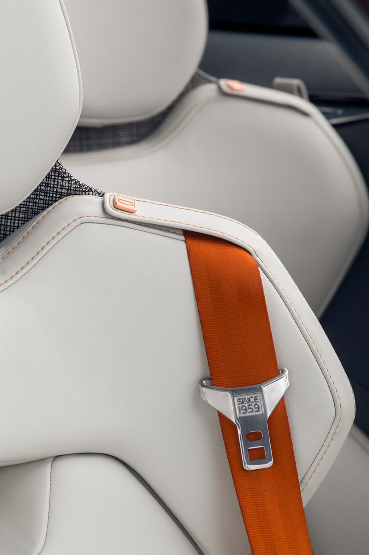 an orange and white seat belt in a car