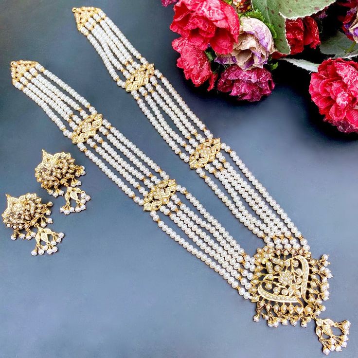 Featured is a minimalistic yet elegant long necklace set in gold plated silver, embellished with freshwater pearls. Elegant Temple Necklace With Gold Beads For Festive Occasions, Kundan Pearl Necklace As A Gift, Kundan Pearl Chain Necklace As A Gift, Gold Hand Set Long Bridal Necklace, Gold Bridal Necklace Hand Set, Festive Pearl Necklaces With Pearl Pendant, Festive Pearl Necklace With Pearl Pendant, Kundan Pearl Necklace With Pearl Pendant For Celebrations, Celebration Kundan Pearl Necklace With Pendant