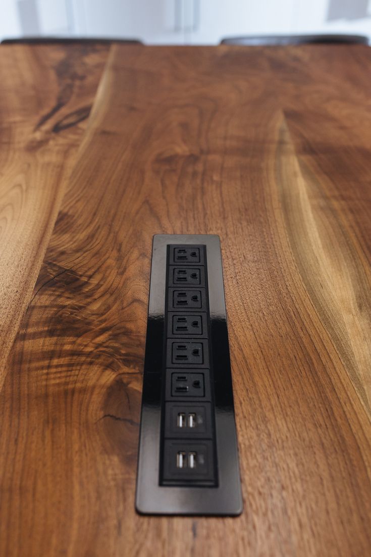 a wooden table with an electrical outlet on it