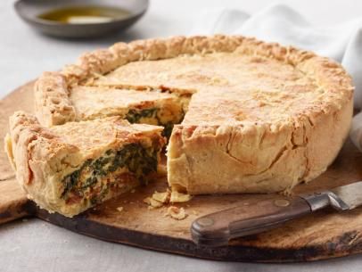 there is a pie on the cutting board