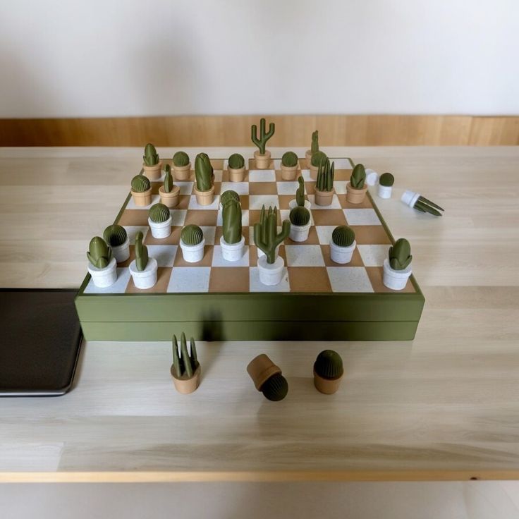 a wooden chess board with cactus plants on it