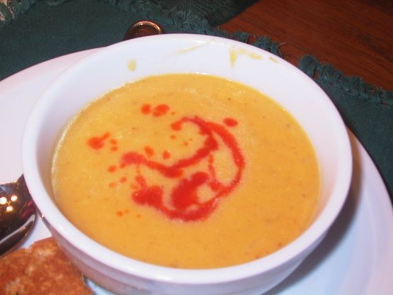 a white bowl filled with soup on top of a plate