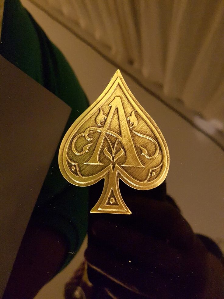 a gold ace playing card sitting on top of a table