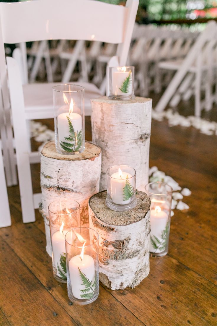 some candles are sitting on top of logs