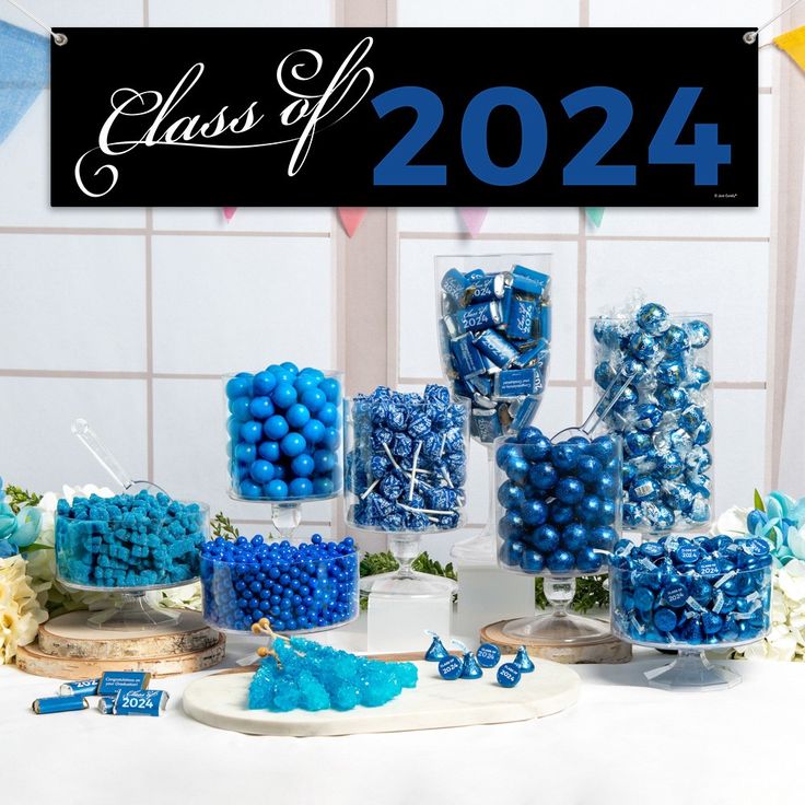 blue and white candies are on display in front of a class of 202 sign