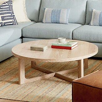 a living room with blue couches and a coffee table in front of the couch