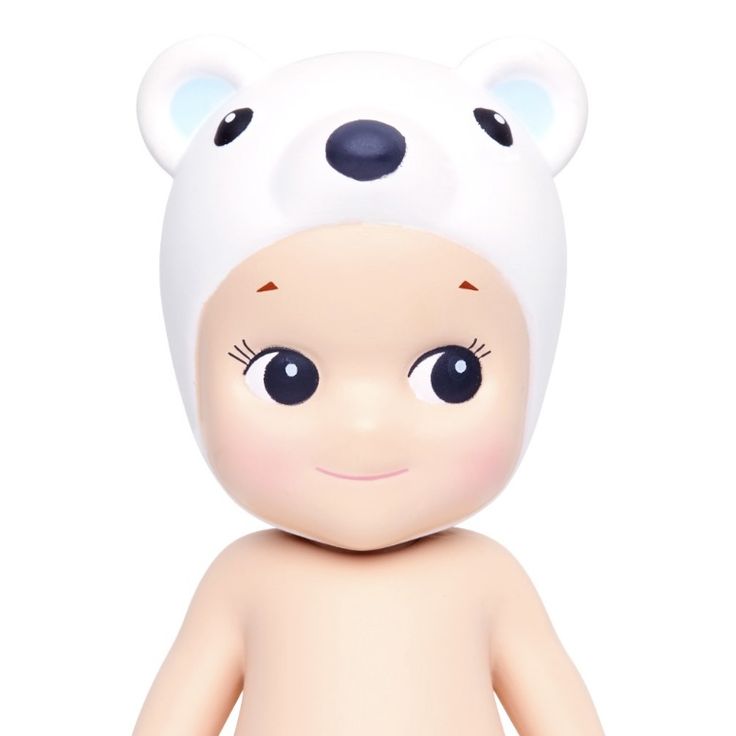 a white teddy bear with big eyes and a hat on top of it's head