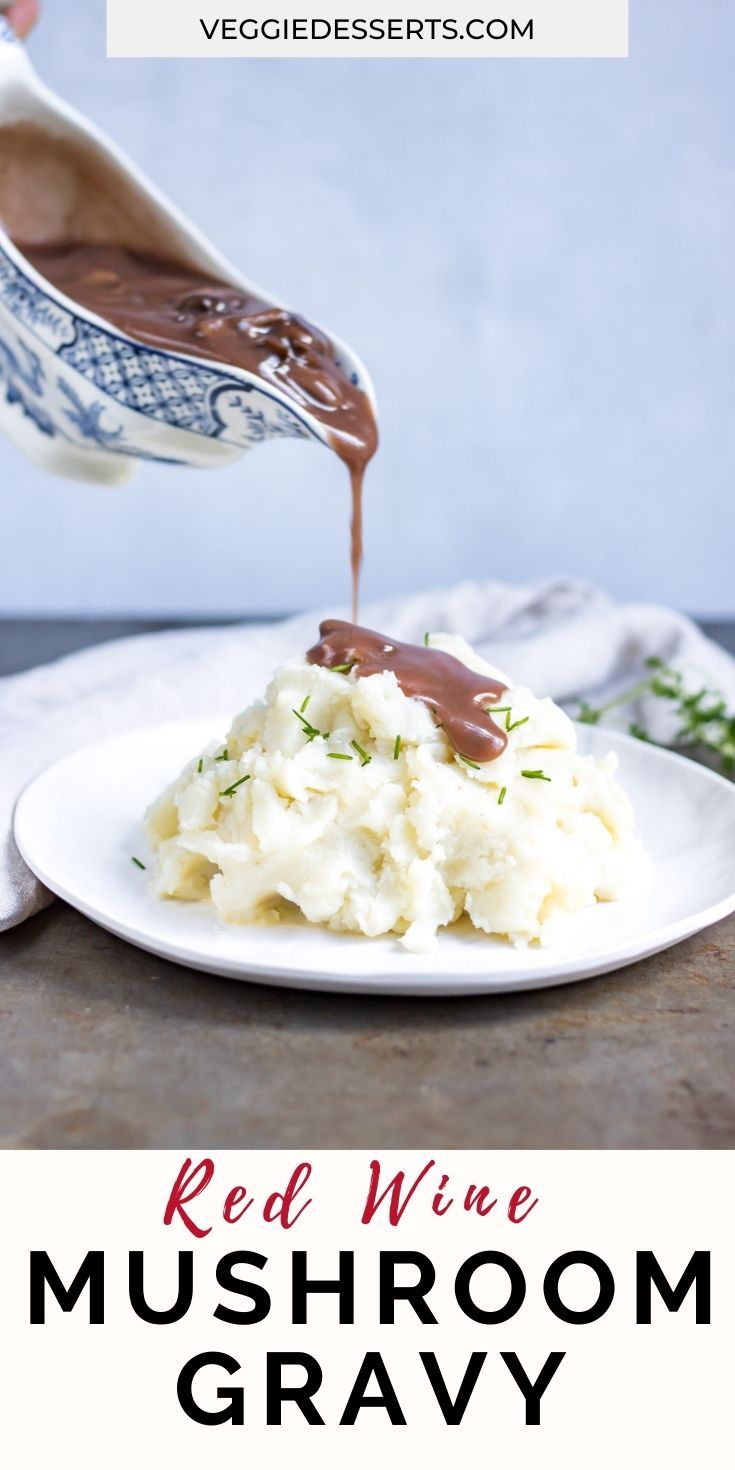 red wine mushroom gravy being poured over mashed potatoes on a white plate