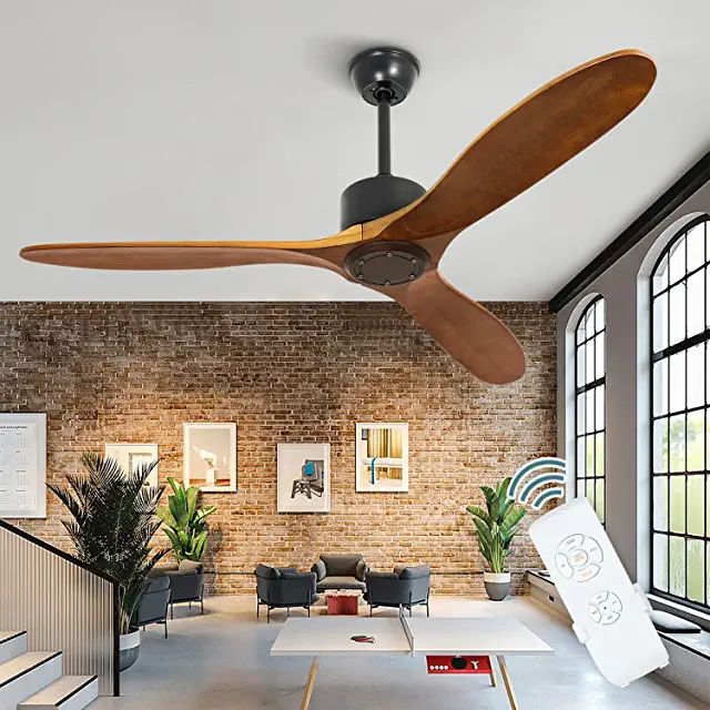 a ceiling fan is hanging from the ceiling in a living room with exposed brick walls