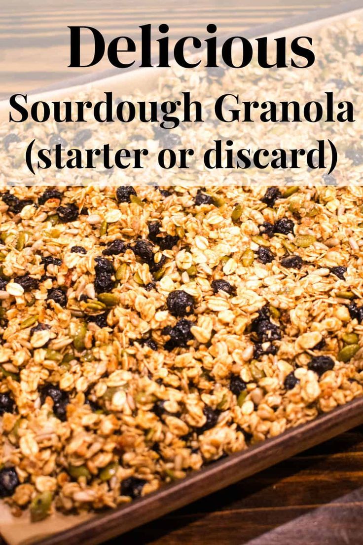 granola with blueberries and raisins in a wooden tray on a table