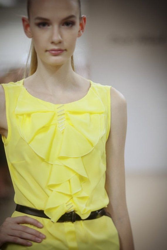 Bright yellow chiffon top, decorated with flounces, yellow ribbon and handstiched beads. Sleeveless. Loose fit.Size 42/12  (bust 96cm/37,8in, waist 78cm/30,7in)Back lenght: 57cm/22,3inMaterials utilised100% Polyester chiffonYellow ribbon.Long beads. Elegant Yellow Summer Blouse, Sleeveless Chiffon Blouse For Party, Yellow Chiffon Summer Top, Yellow Sleeveless Top With Ruffles, Elegant Yellow Summer Tops, Elegant Yellow Tops For Summer, Elegant Yellow Sleeveless Blouse, Elegant Sleeveless Yellow Blouse, Sleeveless Ruffled Chiffon Top